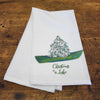 25 Inches White Cotton Dish Towel Featuring a Christmas Tree Sitting on a Green Canoe Design with "Christmas at the Lake" Message at the Bottom