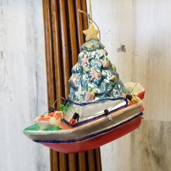 "Glass Ornament Featuring Red Boat With a Sparkling Blue Sea-Inspired Christmas Tree Surrounded by Colorful Light Bulbs and a Life Ring. "