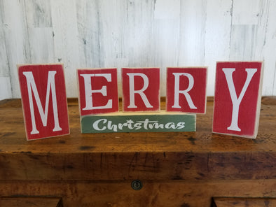 Red and Green Wooden Block Sign Featuring "M-E-R-R-Y" Letters in Every Red Block and "Christmas" Text In a Green Block Sign