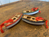 Red, Green and Blue Wooden Row Boat Ornament Featuring Wooden Oars and Life Ring on it